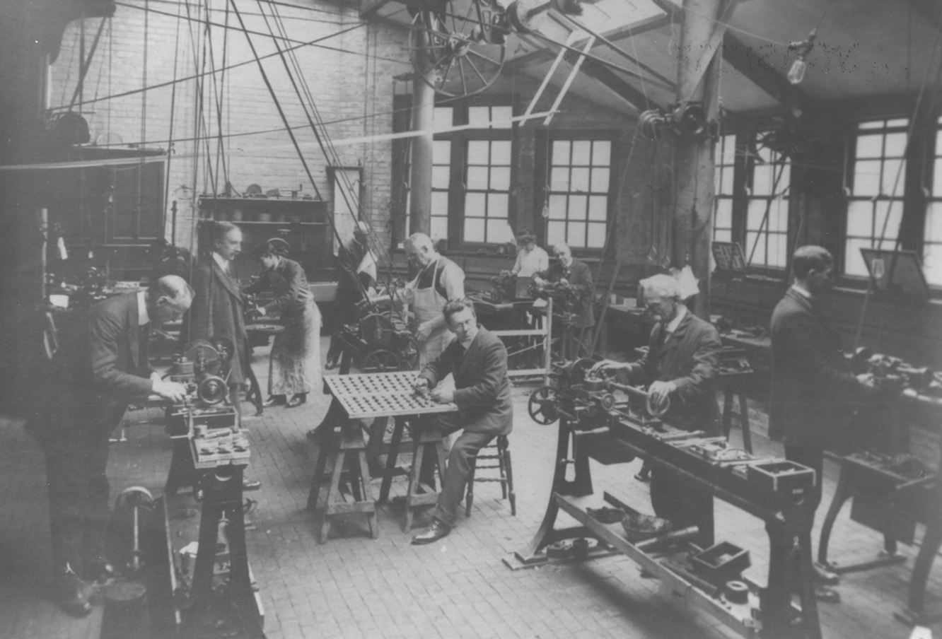 Black and white image shows workers at machines at the Storey Workshops, Lancaster, in 1900.